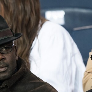 Lilian Thuram et sa compagne Kareen Guiock dans les tribunes du Parc des Princes lors du match du Paris Saint-Germain (PSG) contre l'En Avant Guingamp (EAG) à Paris, le 29 avril 2018 (score final : 2-2). © Cyril Moreau/Bestimage