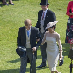 Le prince Harry, duc de Sussex, et Meghan Markle, duchesse de Sussex, à Buckingham Palace le 23 mai 2018 pour une garden party en l'honneur des patronages et associations soutenues par le prince Charles dans le cadre des célébrations de son 70e anniversaire le 14 novembre 2018.