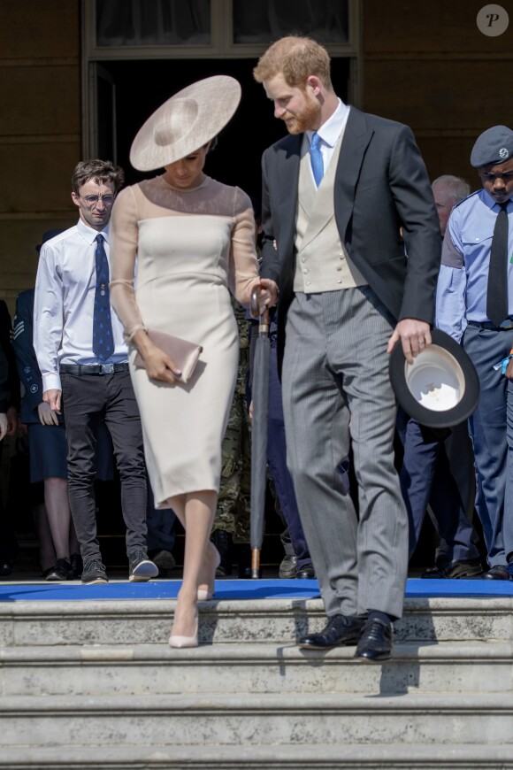 Le prince Harry, duc de Sussex, et Meghan Markle, duchesse de Sussex, à Buckingham Palace le 23 mai 2018 pour une garden party en l'honneur des patronages et associations soutenues par le prince Charles dans le cadre des célébrations de son 70e anniversaire le 14 novembre 2018.