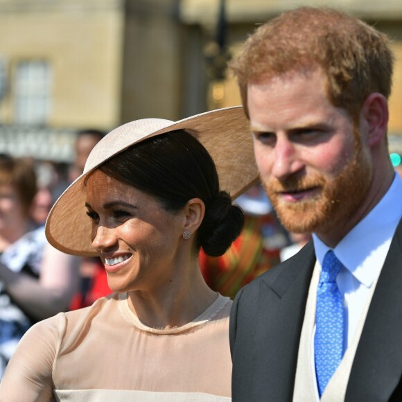 Le prince Harry, duc de Sussex, et Meghan Markle, duchesse de Sussex, à Buckingham Palace le 23 mai 2018 pour une garden party en l'honneur des patronages et associations soutenues par le prince Charles dans le cadre des célébrations de son 70e anniversaire le 14 novembre 2018.