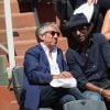 Manu Katché, Richard Anconina dans les tribunes lors des internationaux de France de Roland Garros à Paris le 7 juin 2018. © Cyril Moreau / Bestimage