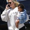 Exclusif - Khloe Kardashian porte sa fille True dans ses bras à son arrivée à Van Nuys en provenance de Palm Springs le 23 avril 2019, où la famille Kardashian a assisté au festival de Coachella. Khloe porte un sweat "Yeezy Sunday Service". Khloe porte des cadeaux (peluches...) qu'elle dépose dans le van à son arrivée. Khloe est arrivée avec sa fille, sa soeur K. Kardashian et ses 3 enfants.