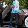 Exclusif - Travis Scott remonte dans sa Lamborghini Aventador, en sortant des bureaux de "Live Nation" à Los Angeles, le 8 juillet 2019.