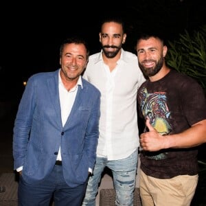 Bernard Montiel, Adil Rami et Yohan Lidon (kickboxeur) assistent à la soirée des 50 ans de l'hôtel le Mas de Bellevue à Saint-Tropez, Côte d'Azur, France, le 8 août 2019. © Jack Tribeca/Bestimage