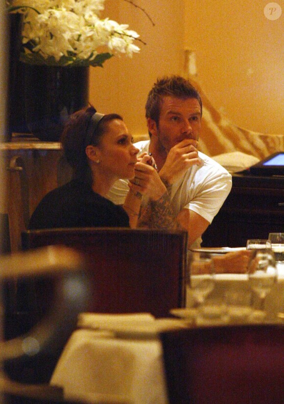 David et Victoria surpris lors d'un moment intime. Les deux tourtereaux dînent en amoureux au Claridges à Londres en février 2009. Un moment de tendresse avant de choisir le menu !