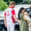 Le prince Harry, Meghan Markle, duchesse de Sussex, et leur fils Archie Harrison Mountbatten-Windsor lors d'un match de polo caritatif à Wokinghan en Angleterre le 10 juillet 2019.