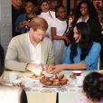 Le prince Harry, duc de Sussex, et Meghan Markle, duchesse de Sussex, en visite dans un e cuisine communautaire dans le District 6 au Cap dans le cadre de leur visite officielle en Afrique du Sud, le 23 septembre 2019.