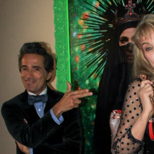 Vincent Darré et Arielle Dombasle lors du vernissage de l'exposition consacrée à l'oeuvre et l'imaginaire de Christian Louboutin "l'Exhibitionniste' (L'Exibition[niste]) au Palais de la Porte Dorée, à Paris, France, le 24 février 2020. © Philippe Baldini/Bestimage