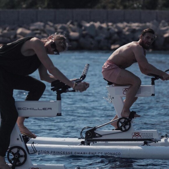 La princesse Charlene de Monaco, soutenue par son mari le prince Albert, s'entraîne avec le champion de MMA Conor McGregor pour le "Calvi – Monaco Water bike Challenge" qui se tiendra en septembre. Sur Instagram, le 20 juillet 2020.