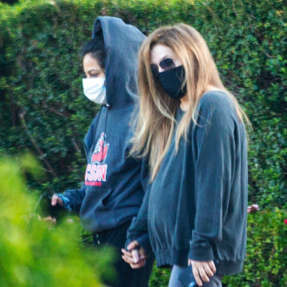 Exclusif - Lisa Marie Presley marche main dans la main avec Diana Pinto (la compagne de Benjamin Keough) dans le quartier de Beverly Hills à Los Angeles pendant l'épidémie de coronavirus (Covid-19). Les deux jeunes femmes se soutiennent depuis la mort de Benjamin. Le 15 juillet 2020