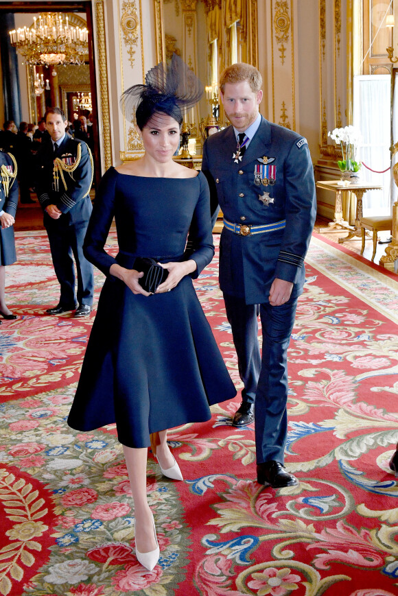 Le prince Harry, duc de Sussex et Meghan Markle, duchesse de Sussex (habillée en Dior Haute Couture par Maria Grazia Chiuri) - La famille royale d'Angleterre à la réception du 100ème anniversaire de la RAF au palais de Buckingham à Londres. Le 10 juillet 2018