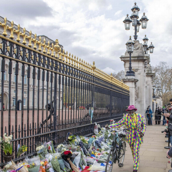 Les Anglais viennent rendrent hommage au prince Philip, duc d'Edimbourg devant les grilles de Buckingham Palace à Londres le 11 avril 2021.