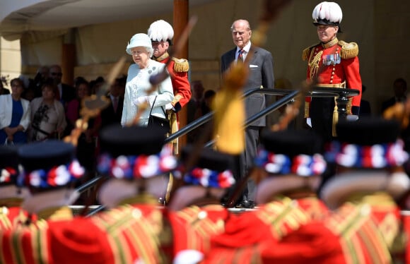 La reine Elisabeth II d'Angleterre et le prince Philip, duc d'Edimbourg passent en revue les gardes de la reine dans les jardins de Buckingham le 9 juillet 2015.