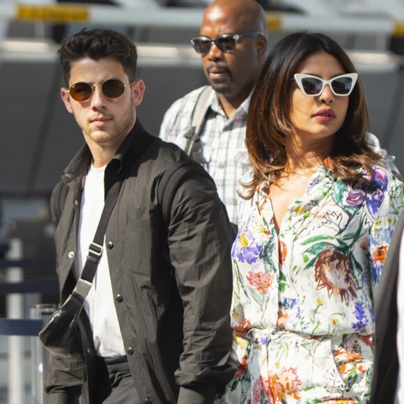 Nick Jonas et sa femme Priyanka Chopra se tiennent la main en arrivant à l'aéroport JFK à New York. Le 27 juillet 2019.