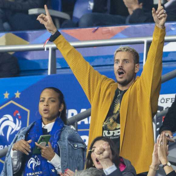 M. Pokora (Matt Pokora), sa femme Christina Milian assistent au match de la 5ème et avant-dernière journée de Ligue des nations entre la France et l'Autriche (2-0) au Stade de France à Saint-Denis le 22 septembre 2022.