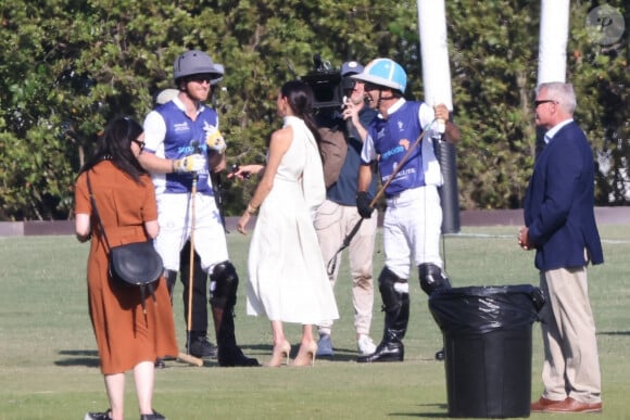Palm Beach, FL - Meghan Markle wows in a white dress and towering heels as she and Prince Harry arrive hand-in-hand at the the Royal Salute Polo Challenge in Miami. The Happy couple were surrounded by a film crew from Duke's new Netflix show about the elitist sport. Pictured: Prince Harry, Meghan Markle 