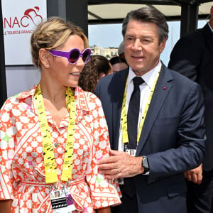 Christian Estrosi et sa femme Laura Tenoudji - Le prince Albert II de Monaco et la princesse Charlene ont donné le départ de la dernière étape du Tour de France 2024, un contre la montre entre Monaco et Nice en compagnie de Christian Estrosi, le maire de Nice, sa femme, Laura Tenoudji et Christian Prudhomme, le directeur du Tour de France, le 21 juillet 2024. Ce Tour est remporté pour la troisième fois par le Slovène Tadej Pogačar, UAE Team Emirates avec une sixième victoire d'étape, en s'imposant au contre-la-montre final. © Bruno Bebert/Bestimage  Prince Albert II of Monaco and Princess Charlene received an unusual gift: an electric Solex in the colors of the famous Cochonou brand. The brand with its red and white colors and its famous "bob" caps won over the princess, who had fun covering her husband with it in a shared fit of laughter - Prince Albert II of Monaco and Princess Charlene gave the start to the final stage of the 2024 Tour de France, a time trial between Monaco and Nice in the company of Christian Estrosi, the mayor of Nice, his wife, Laura Tenoudji and Christian Prudhomme, the director of the Tour de France, on July 21, 2024. This Tour is won for the third time by the Slovenian Tadej Pogačar, UAE Team Emirates with a sixth stage victory, by winning the final time trial. 