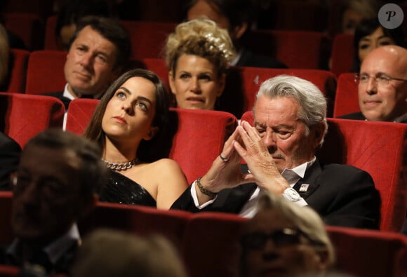 Alain Delon (avec un badge Paris Match d'une ancienne couverture du magazine titrant "Alain Delon, mes deux amours, Rosalie et Anouchka) et sa fille Anouchka (Robe Elie Saab) - Remise de la Palme d'Honneur à Alain Delon lors du 72ème Festival International du Film de Cannes. On may 19th 2019 © Jacovides-Moreau / Bestimage