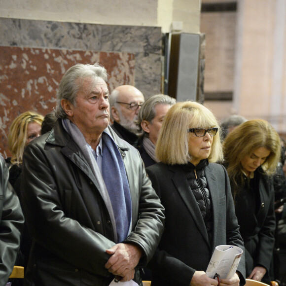 Alain Delon et Mireille Darc - Hommage a Georges Lautner en l'eglise Saint-Roch a Paris. Le 5 decembre 2013