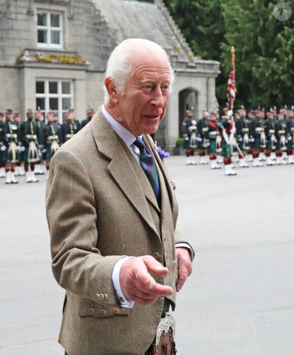 Le roi Charles III d'Angleterre, accueilli par des soldats de la compagnie Balaklava, 5e bataillon du Royal Regiment of Scotland devant le château de Balmoral (Ecosse), où le souverain débute ses vacances d'été, le 19 août 2024.