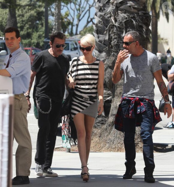 Johnny Hallyday, son épouse Laeticia, et leur ami Christian Audigier à Los Angeles. 15 avril 2011