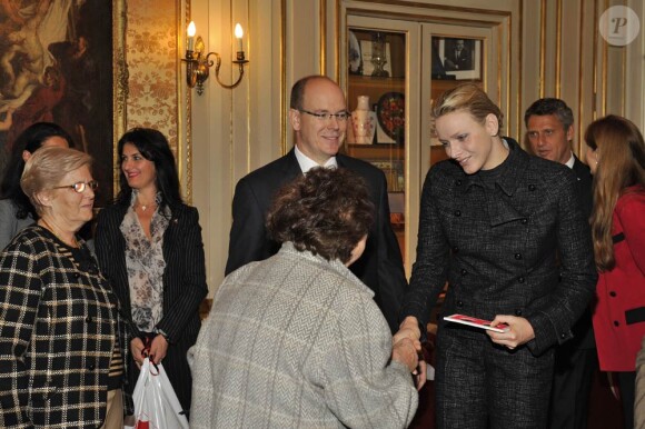 La princesse Charlene avec le prince Albert et la princesse Stéphanie le 17 novembre 2011 pour la distribution de colis alimentaires dans les locaux de la Croix Rouge monégasque.