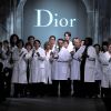Suivant le licenciement de John Galliano à la tête de Dior, ce sont les mains de l'atelier qui sont venus saluer la foule lors du défilé automne-hiver 2011 à Paris. Le 4 mars 2011.