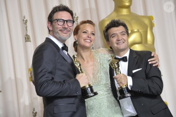 Thomas Langmann lors des Oscars en février 2012, avec Michel Hazanavicius et Bérénice Bejo.