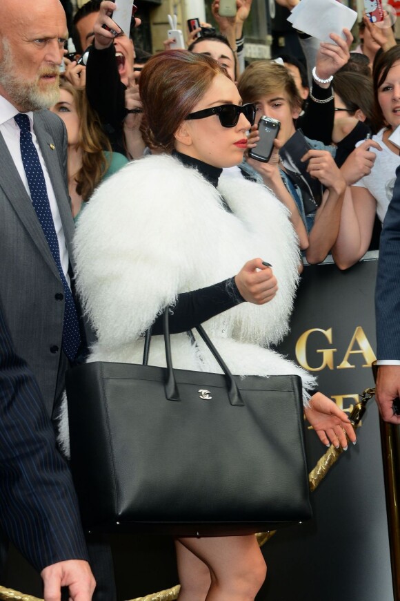 Lady Gaga à Paris dans une fourure blanche, sac Chanel à la main, adopte un look plus sage pour surprendre ses fans parisiens