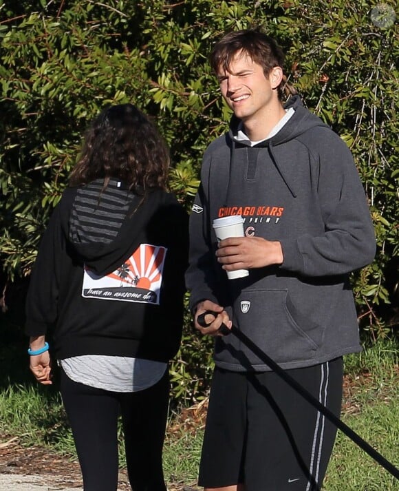 Ashton Kutcher et Mila Kunis promènent leur chien dans les rues d'Hollywood, le 7 Janvier 2013. Ashton Kutcher tient à la main une boisson Starbucks.