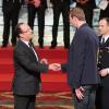 François Hollande et Alain Bernard lors de la cérémonie de remise de la Légion d'honneur aux sportifs médaillés à Londres lors des Jeux olympiques, au palais de l'Elysée le 1er mars 2013 à Paris