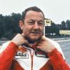 Coluche sur une moto de course