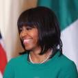 Michelle Obama, souriante à la Maison Blanche à l'occasion d'un dîner d'Etat le 19 mars 2013