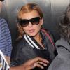 Lindsay Lohan souriante à son arrivée à l'aéroport de Los Angeles, le 27 mars 2013. Elle rentre chez elle à New York.