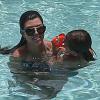 Kourtney Kardashian et Scott Disick se baignent dans une piscine avec leurs enfants Mason et Penelope a Miami, le 22 juillet 2013.  Please hide children's face prior to the publication Kourtney Kardashian spends the day with her family and friends at the pool in Miami, Florida on July 22, 2013.22/07/2013 - Miami
