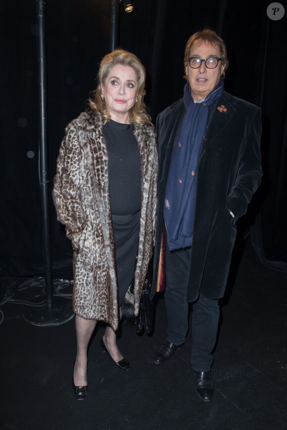 Catherine Deneuve et Gilles Dufour arrive au Carreau du Temple pour assister au défilé Saint Laurent Paris le 3 mars 2014.