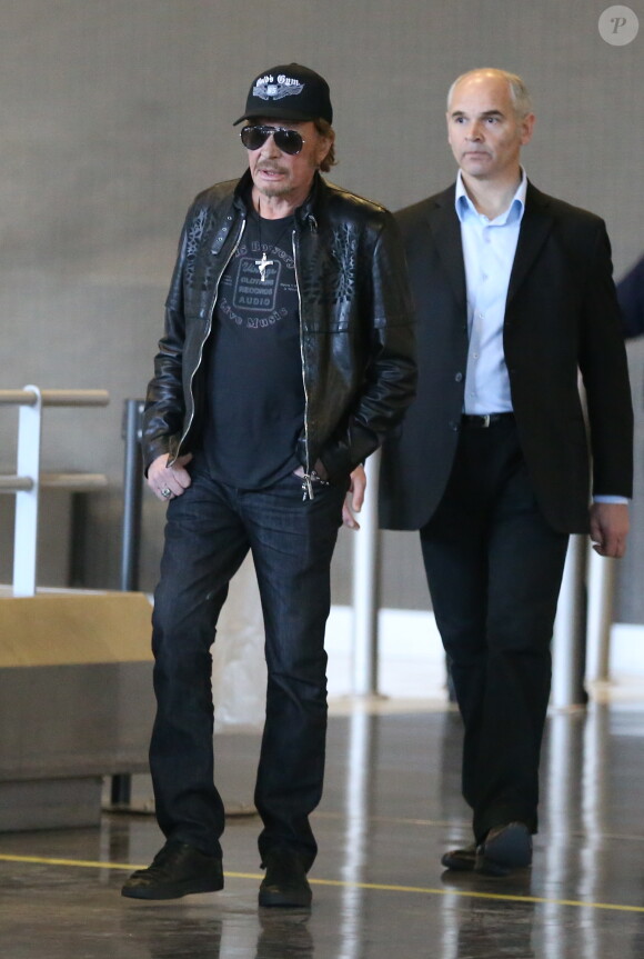 Johnny Hallyday à son arrivée à l'aéroport de Roissy Charles de Gaulle le 11 mars 2014. Le taulier, arrivé seul, est à Paris pour la promotion du film de Claude Lelouch "Salaud, on t'aime".