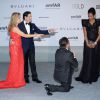 John Travolta et sa femme Kelly Preston, Oscar Generale, Denny Mendez - Photocall du 21e gala de l'amfAR à l'Eden Roc au Cap d'Antibes en marge du 67e Festival du film de Cannes, le 22 mai 2014.