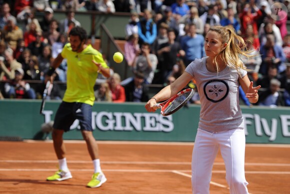 Laurent Lokoli et Alizé Cornet lors de la journées des Enfants de Roland-Garros, à Roland-Garros, le 24 mai 2014 à Paris