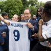 François Hollande avec les filles du Paris FC et du Cosmo Ermont-Taverny, à la mi-temps du match France - Nigeria, dans les jardins de l'Elysée, le 30 juin 2014