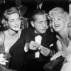 Lauren Bacall, Humphrey Bogart et Marilyn Monroe lors de la présentation du film Comment épouser un millionnaire dans lequel les deux actrices jouent, à New York en 1953