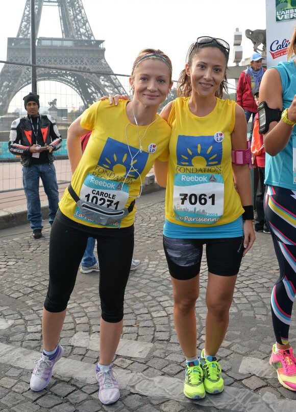 Fabienne Carat et sa soeur Carole lors de la course "La Parisienne 2014" pour la lutte contre le cancer, au Champs de Mars à Paris, le 14 septembre 2014