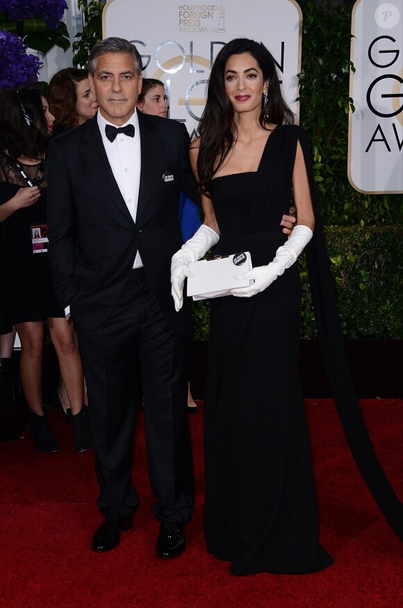 George Clooney (en Armani) et sa femme Amal Alamuddin Clooney (en Dior) lors des Golden Globes Awards à Los Angeles le 11 janvier 2015