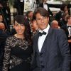 Giuseppe et sa compagne Hinda, dans une robe Paule Ka, arrivent au Palais des Festivals pour le film Jimmy's Hall lors du 67e Festival de Cannes, le 22 mai 2014