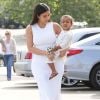 Kim Kardashian, tout de blanc vêtue avec un top et une jupe Alaïa, quitte une église avec sa fille North. Woodland Hills, le 5 avril 2015.