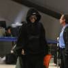 Rihanna à l'aéroport LAX, porte un pull, un jogging et un bomber oversize Vetements, un sac à dos Givenchy et des sandales Puma. Le 6 octobre 2015.