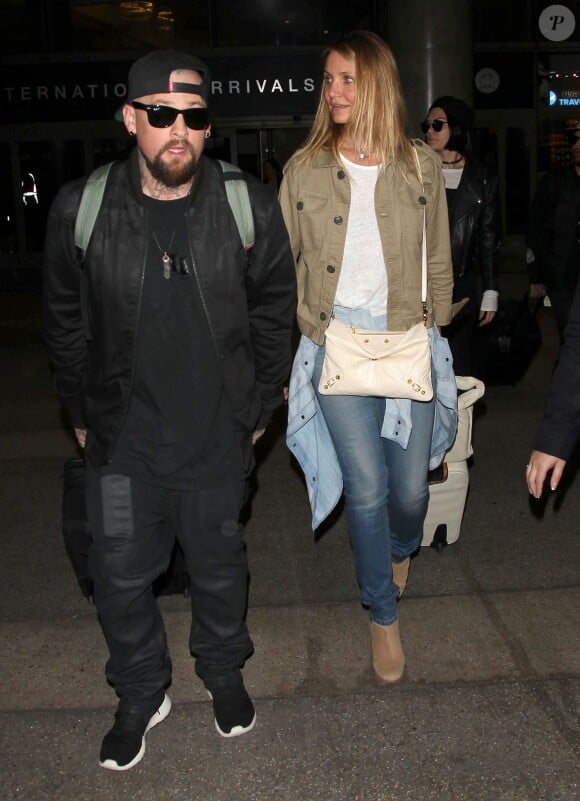 Cameron Diaz et son mari Benji Madden arrivent à l'aéroport de Los Angeles de retour d'Australie, le 31 août 2015.