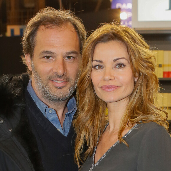 Ingrid Chauvin et son mari Thierry Peythieu au salon du livre à la porte de Versailles à Paris le 22 mars 2015.