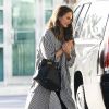Chrissy Teigen arrive à l'aéroport de Miami, habillée d'une veste rayée Zimmermann, d'un jean et de bottines noires. Le mannequin porte un sac Hermès. Le 27 décembre 2016.