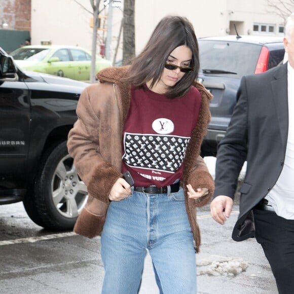 Kendall Jenner à New York, porte une veste en shearling, un pull Louis Vuitton, un jean et des bottines en peau de reptile. Le 11 février 2017.